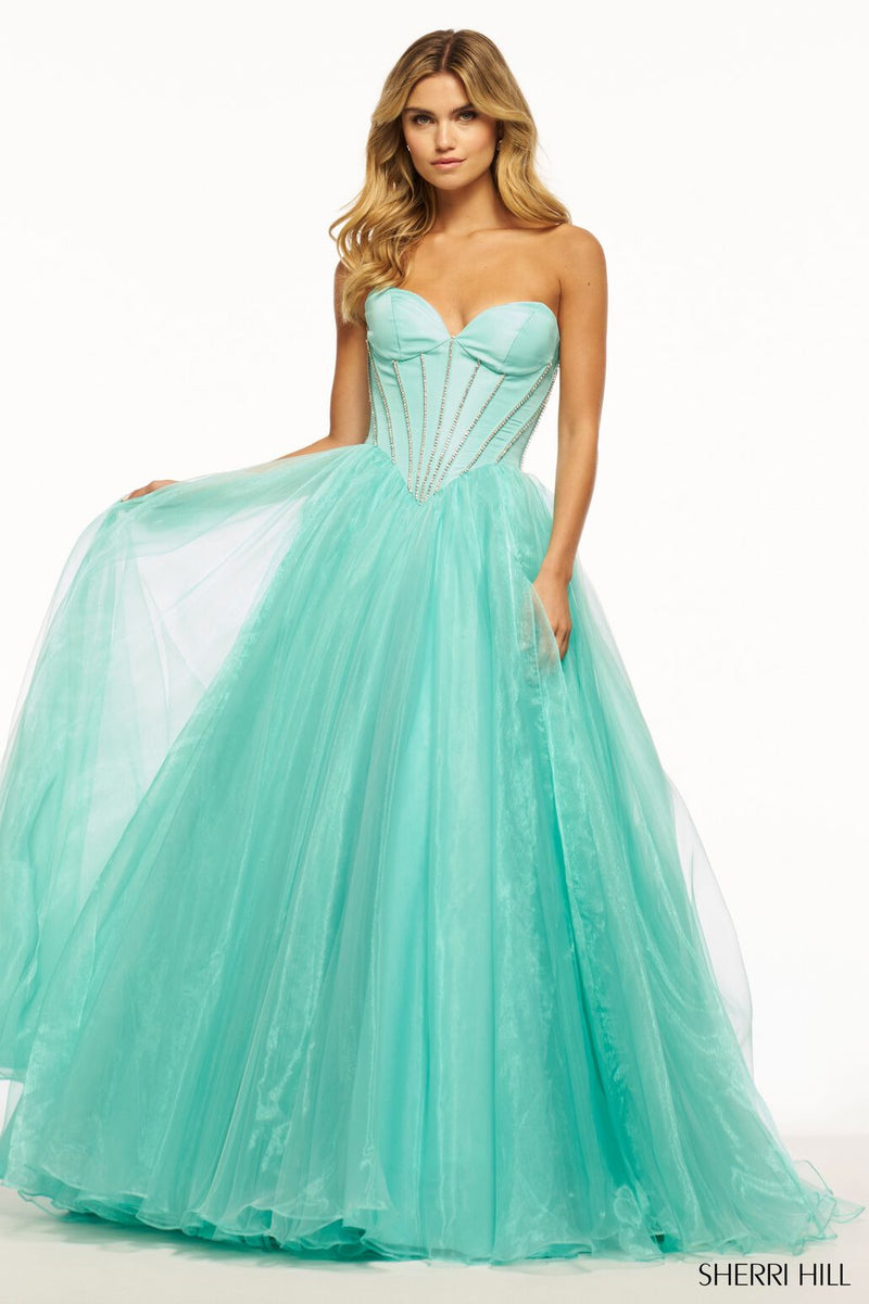 This ballgown features a strapless sweetheart neckline with corset boning embellished with rhinestones on the taffeta fabric bodice. The organza skirt creates a voluminous A-line silhouette, which could be just the vibe for your next prom or formal event.  Sherri Hill 56028