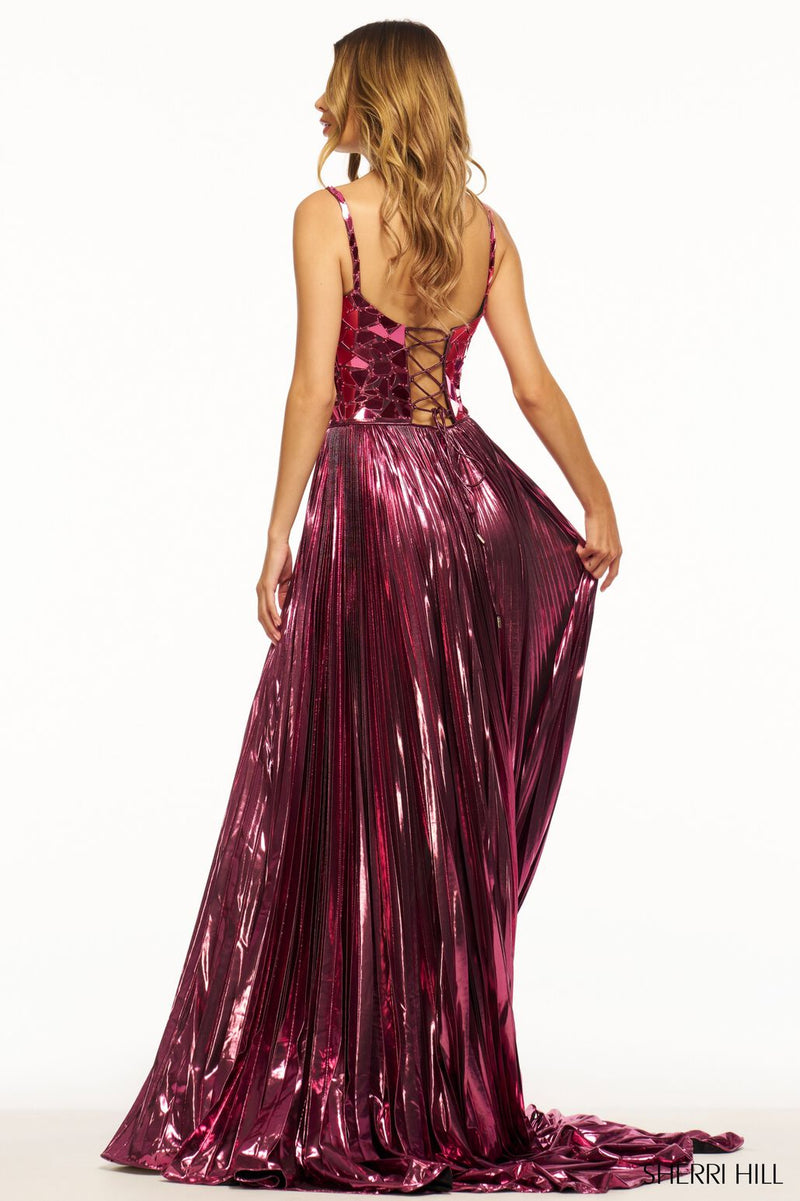This Sherri Hill gown features metallic pleated fabric with an A-line silhouette with cut glass embellished bodice and a lace-up back. This dress is elegant with beautiful details that make it stand out. This could be the dream dress for your next prom or formal event!   Sherri Hill 56030