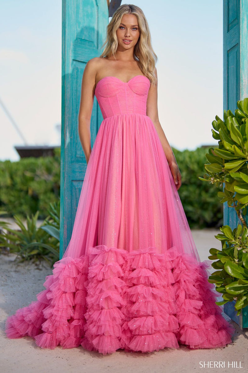 This Sherri Hill ballgown features a strapless neckline with a corset top and a ruffled embellished skirt and a train to follow. It is effortlessly stunning, an impeccable choice for your next prom or formal event.   Sherri HIll 56040