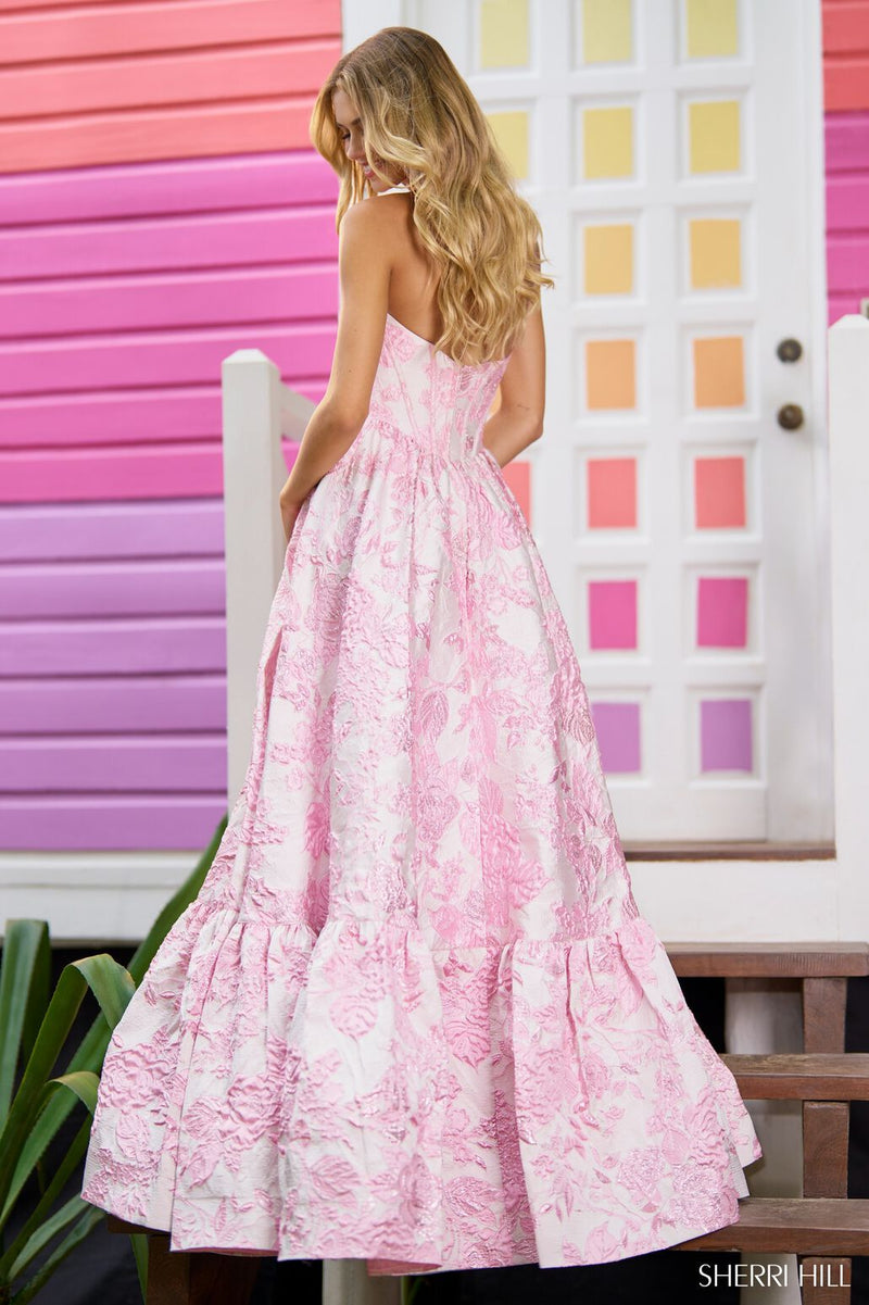 This Sherri Hill ballgown features a strapless neckline, brocade textured fabric and a corset bodice. This fabric is a statement and creates depth and interest. This could be the ideal choice for your next prom or formal event!  Sherri Hill 56055