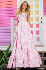 This Sherri Hill ballgown features a strapless neckline, brocade textured fabric and a corset bodice. This fabric is a statement and creates depth and interest. This could be the ideal choice for your next prom or formal event!  Sherri Hill 56055