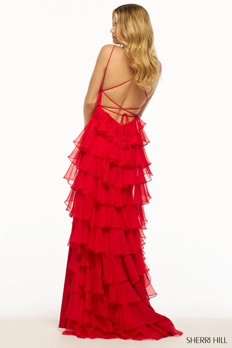 This Sherri Hill gown features stretch satin fabric with a fitted silhouette. The lace-up back and chiffon ruffle over the back of the skirt are the unique details that make this dress feminine and playful. This could be the ideal dress for your next prom or formal event!  Sherri Hill 56078