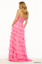 This Sherri Hill gown features a leaf lace high neckline with a beaded choker and 3D flower. It has a layered ruffle chiffon skirt and slit. This dress is playful and unique and could be perfect for your next prom or formal event! Sherri Hill 56083