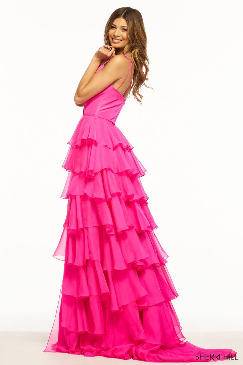 This Sherri Hill gown features ruffle chiffon details with an A-Line silhouette, a skirt slit and a taffeta bodice. This playful dress could be ideal for your next prom or formal event!  Sherri Hill 56108