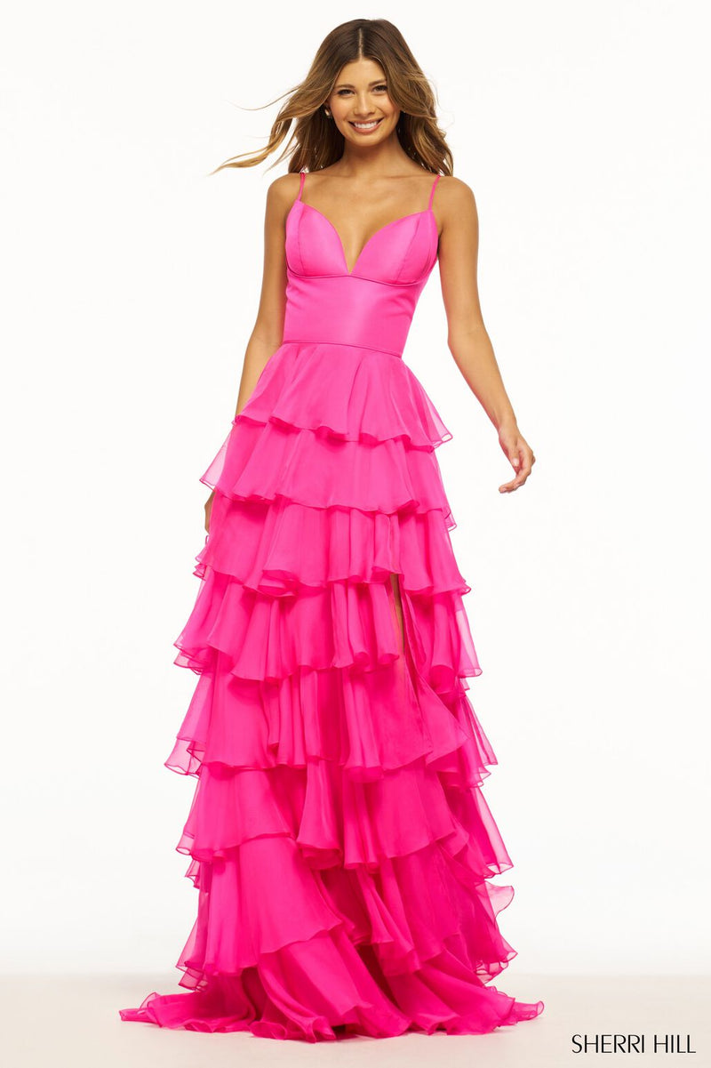 This Sherri Hill gown features ruffle chiffon details with an A-Line silhouette, a skirt slit and a taffeta bodice. This playful dress could be ideal for your next prom or formal event!  Sherri Hill 56108