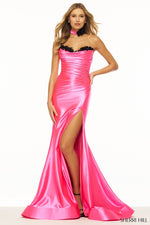 This Sherri Hill gown features a strapless neckline, corset with a ruched bodice, flower embellishments, high slit and a lace-up back. This dress also features a slight train for that extra elegance. This dress is distinctive and gives red-carpet vibes which could be the perfect fit for your next prom or formal event!  Sherri Hill 56119