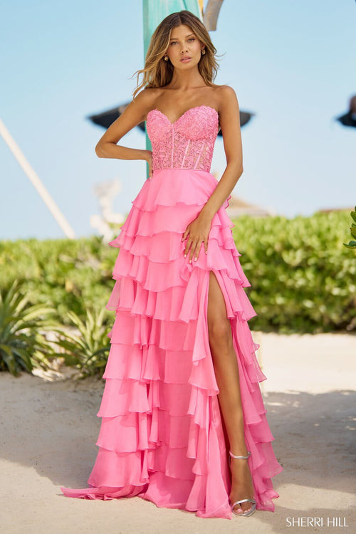 This Sherri Hill strapless gown features a leaf lace corset top, a chiffon ruffle skirt with a slit, and lace-up back. A stunning choice for your next prom or pageant.   Sherri Hill 56162