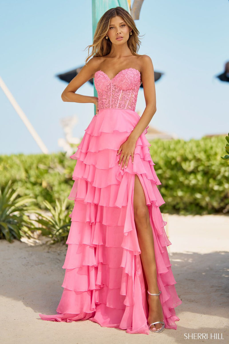 This Sherri Hill strapless gown features a leaf lace corset top, a chiffon ruffle skirt with a slit, and lace-up back. A stunning choice for your next prom or pageant.   Sherri Hill 56162