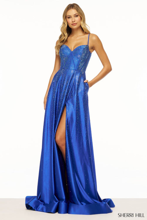 This Sherri Hill gown features an A-line silhouette with a corset bodice, lace-up back, and a skirt slit. The hotfix jewels elevate this dress to be just that much more special. Could this be the one for your next prom or formal event?   Sherri Hill 56190