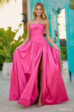 This dress features a strapless neckline with a asymmetrical drop waist with pleat gathering. This dress has taffeta fabric with a skirt slit. This dress is effortless and gives a bit of 90's vibe, with a modern flair. Choose this stunning gown for your next prom or formal event.   Sherri Hill 56197