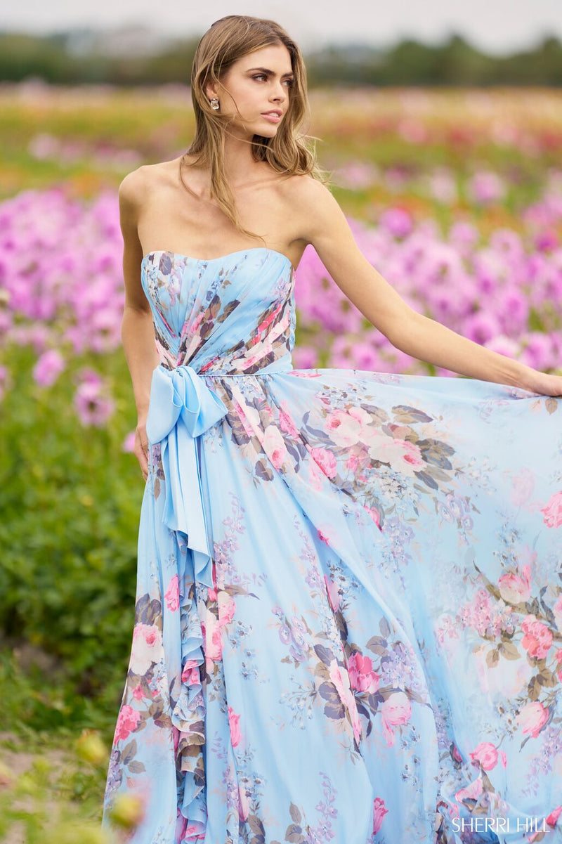 <p>This gown features a strapless neckline with gathered fabric on the bodice and a bow along the waistline. This fabric is a stunning floral print that flows effortlessly creating an A-line silhouette. Style this dress to make it your own at your next prom or formal event!</p> <p>Sherri Hill 56234</p>