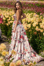 This dress features floral print satin fabric with ruffle embellishments throughout the bodice and skirt with a skirt slit. The neckline is v-neck with spaghetti straps and ties at the top. This gown is romantic and unique and could be perfect for your next prom or formal event.   Sherri Hill 56256