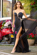 This silk gown features a one-shoulder neckline with a deep V illusion, beaded embellishments along the bodice and strap, a high skirt slit, and a side chiffon cape. This dress could be ideal for your next pageant, prom or formal event!  Sherri Hill 56357