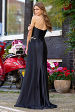 This silk gown features a one-shoulder neckline with a deep V illusion, beaded embellishments along the bodice and strap, a high skirt slit, and a side chiffon cape. This dress could be ideal for your next pageant, prom or formal event!  Sherri Hill 56357