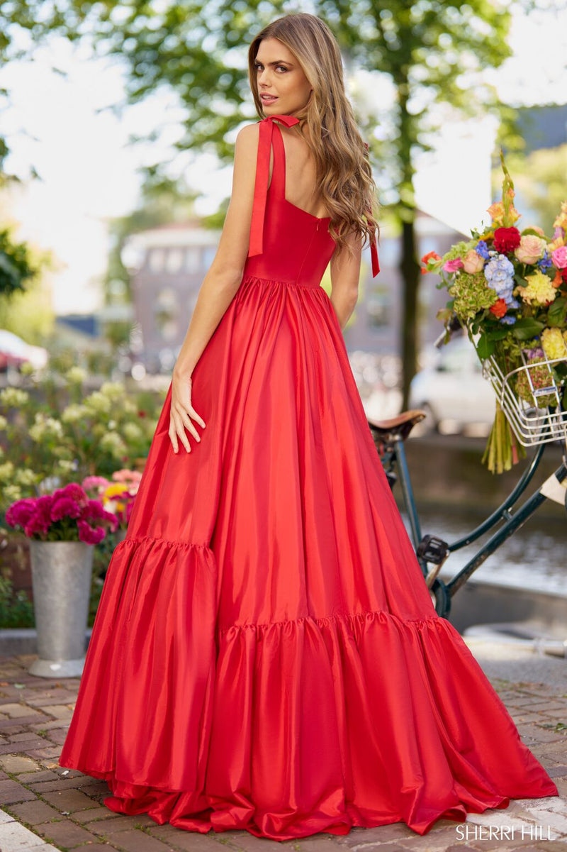 This dress features a sweetheart neckline with 1 inch straps that tie at the top, a full skirt, and an A-line silhouette. This dress is romantic and feminine and could be styled to make it your own at your next prom or formal event.  Sherri Hill 56370