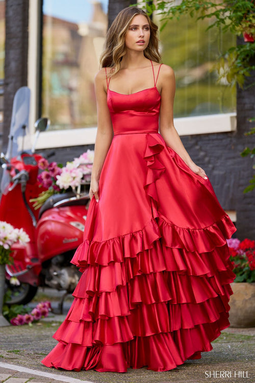 <p>This stunning gown features a straight across neckline with double spaghetti straps and an open lace-up back. The A-line silhouette features a skirt with ruffle tiers adding slight volume and design interest. This dress may be just the vibe for your next prom or formal event.</p> <p>Sherri Hill 56373</p>