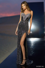 This gown features a strapless neckline with a beaded corset bodice a fully sequined skirt with a high slit and a fitting silhouette. This dress is glamorous and could be a stunning choice for your next pageant, prom or formal event.  Sherri Hill 56560