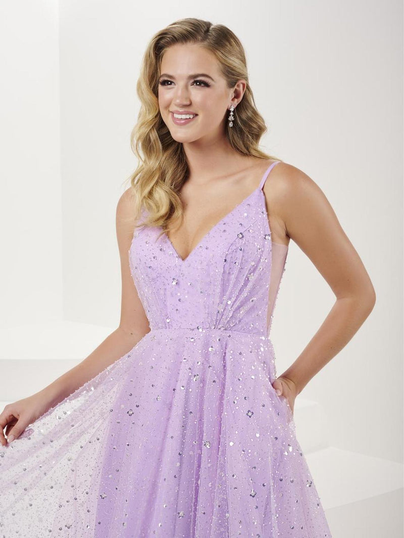 This dress features a v-neckline with spaghetti straps, sequin-adorned tulle fabric with an A-line silhouette. This dress is an enchanting choice for your next prom or formal event.  HOW 16066