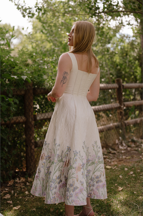 This tea length gown features a brocade foil design, a corset-style top with hidden cups, pockets, and thick straps with a full zippered back. Style this dress to make it your own at your next homecoming or formal event!

AG 11009