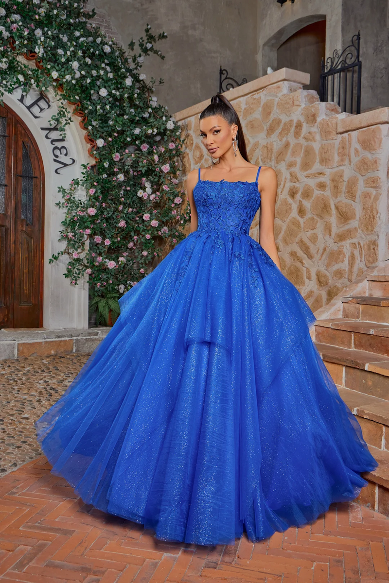 This dress features a straight across neckline with spaghetti straps and a lace-up back. The bodice is lace while the dramatic skirt has glitter tulle for that extra volume. Style this dress to make it your own at your next prom or formal event.

JAD J26001