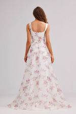 This dress features a ruched bodice and small printed flowers flowing throughout this A-line silhouette. It has a square neckline and 1-inch straps, and organza fabric that could be ideal for your next prom or formal event.   JAD J23024