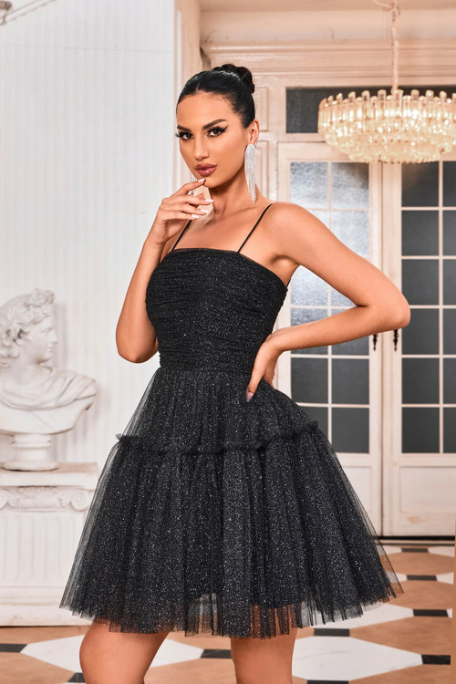 This cocktail dress features a straight across neckline with spaghetti straps and a lace-up back. The glitter tulle fabric creates an A-line silhouette and a playful vibe. Style this dress to make it your own at your next homecoming, sweethearts or formal event.  JAD J24090
