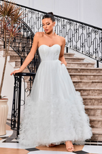 This dress features a strapless neckline with a corset bodice, tulle fabric with 3D detailing on the skirt, a lace-up back, and an A-line silhouette. The voluminous skirt creates drama and could be an amazing option for your next prom or formal event.   JAD J24012