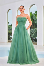 This dress features a strapless neckline with a cinched waistline, tulle fabric and pockets. This dress has an A-line silhouette and gives red-carpet vibes. It is elegant and timeless and ideal for your next prom or formal event.  JAD J24003