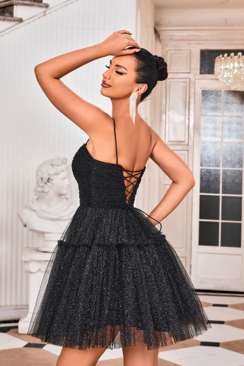 This cocktail dress features a straight across neckline with spaghetti straps and a lace-up back. The glitter tulle fabric creates an A-line silhouette and a playful vibe. Style this dress to make it your own at your next homecoming, sweethearts or formal event.  JAD J24090