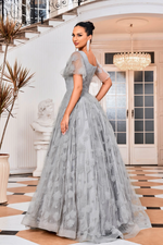 This modest dress features a square neckline with butterfly sleeves, fabric with 3D floral detailing, and an A-line silhouette. This gown is a great option if you are looking for a dress with a bit more coverage but don't want to sacrifice style. This is an elegant and modern choice.   JAD J24008
