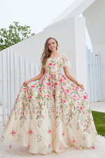 This ballgown features a square neckline with sheer tulle short sleeves, and embroidered floral embellishments throughout the gown. This dress is ethereal and bohemian and ideal for your next prom or formal event.  JAD J23016