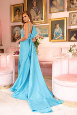 This dress features a straight across neckline with 1-inch straps, a dramatic bow in the back with a train. The bodice is embellished with crystal beading and a fitted silhouette with a slit. Style this dress to make it your own at your next prom, pageant or formal event.

ARY 40142