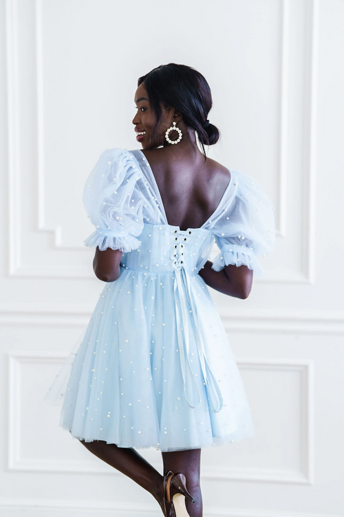 Made from high quality tulle, this mini dress is covered in hand-placed pearls. It features double-lined tulle sleeves and a corset-style top in a mini length and lace-up back. This may be the perfect dress for your next homecoming or formal event.

AG 11008