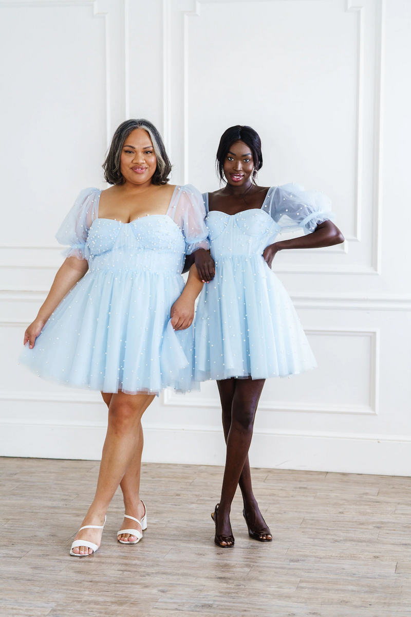 Made from high quality tulle, this mini dress is covered in hand-placed pearls. It features double-lined tulle sleeves and a corset-style top in a mini length and lace-up back. This may be the perfect dress for your next homecoming or formal event.

AG 11008