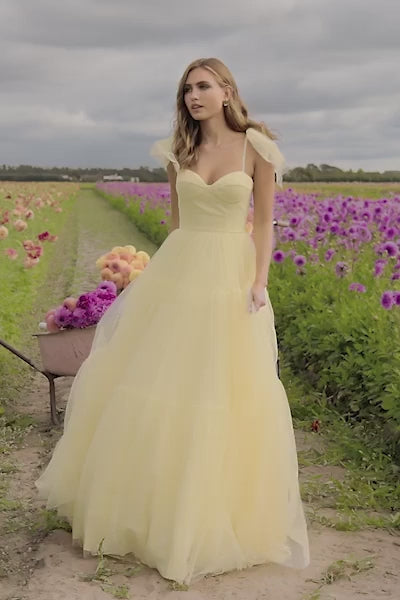 This Sherri Hill ballgown features Swiss dot fabric with bow ties on the spaghetti straps. This dress is feminine and playful, perfect for your next prom or formal event. Sherri Hill 56126