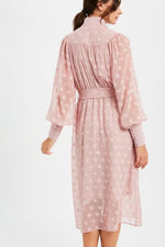 This LE LD0703 cocktail dress in mauve features a high neckline, a polka dot sheer pattern, and buttons on the cuffs. 