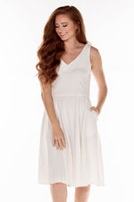 This ERE 3915 flowy cocktail dress in white features a V-neckline on the bodice and pockets. 