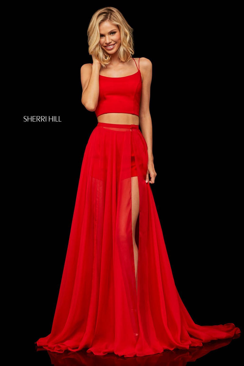This red Sherri Hill 52918 two-piece top with lace up back with shorts and detachable chiffon over skirt. 