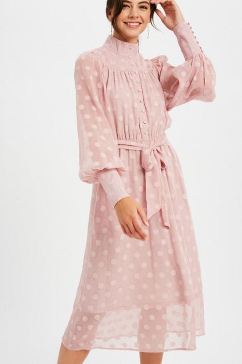 This LE LD0703 cocktail dress in mauve features a high neckline, a polka dot sheer pattern, and buttons on the cuffs. 