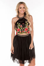 This black DJ 4338 two-piece cocktail dress has a floral bodice and tulle skirt.