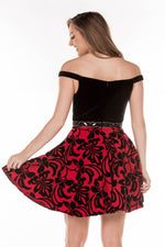 This JE E75033 flowy cocktail dress has a simple bodice and bold printed skirt.