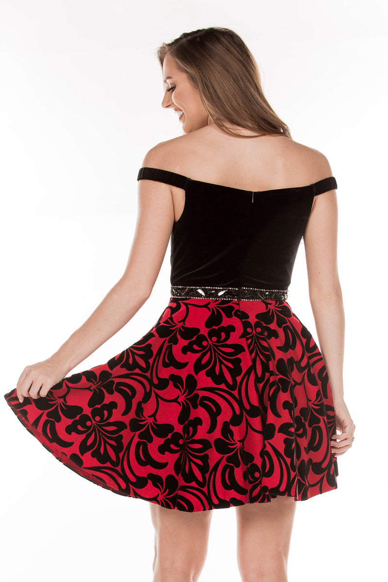 This JE E75033 flowy cocktail dress has a simple bodice and bold printed skirt.
