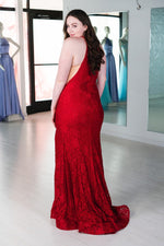 This Sherri Hill 53361 fitted stretch lace dress in dark red features a high cut halter style neckline and a skirt slit.