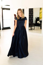 This Mac Duggal 25947 A-line gown in navy features a modest cap sleeve with a high neckline and back. 