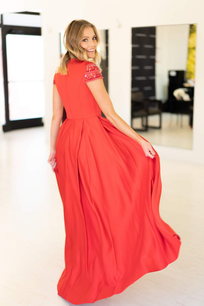 This Mac Duggal 25947 A-line gown in red features a modest cap sleeve with a high neckline and back. 