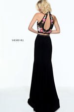 This Sherri Hill 51059 black fitted boho gown has a floral print bodice and fitted skirt.