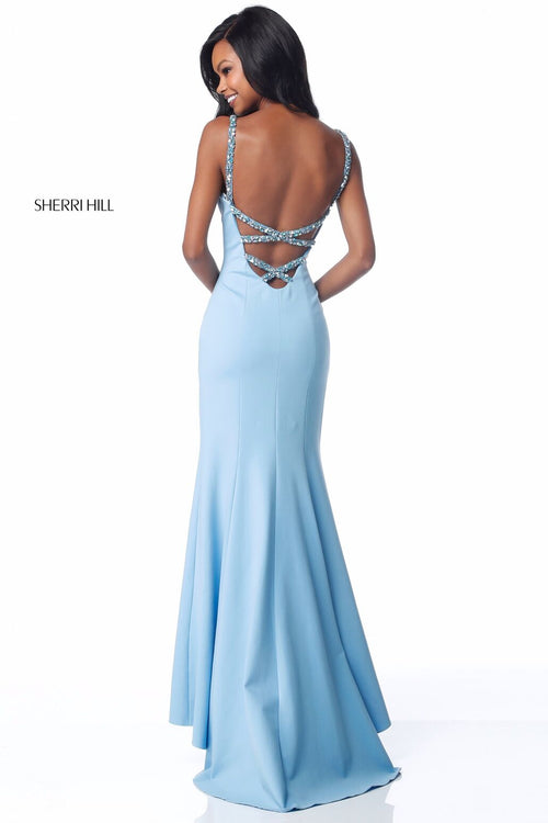 This Sherri Hill 51777 fitted jersey gown in light blue features bead encrusted straps and an open back.