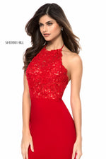 This Sherri Hill 51844 gown in red features a lace appliqué halter bodice and a jersey skirt with an open back.