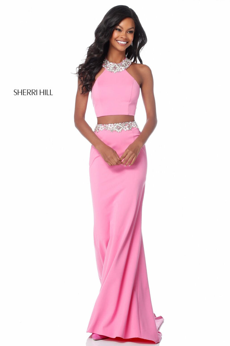 This Sherri Hill 51911 jersey two-piece gown features a high neck halter bodice and a fitted skirt with a beaded belt. 