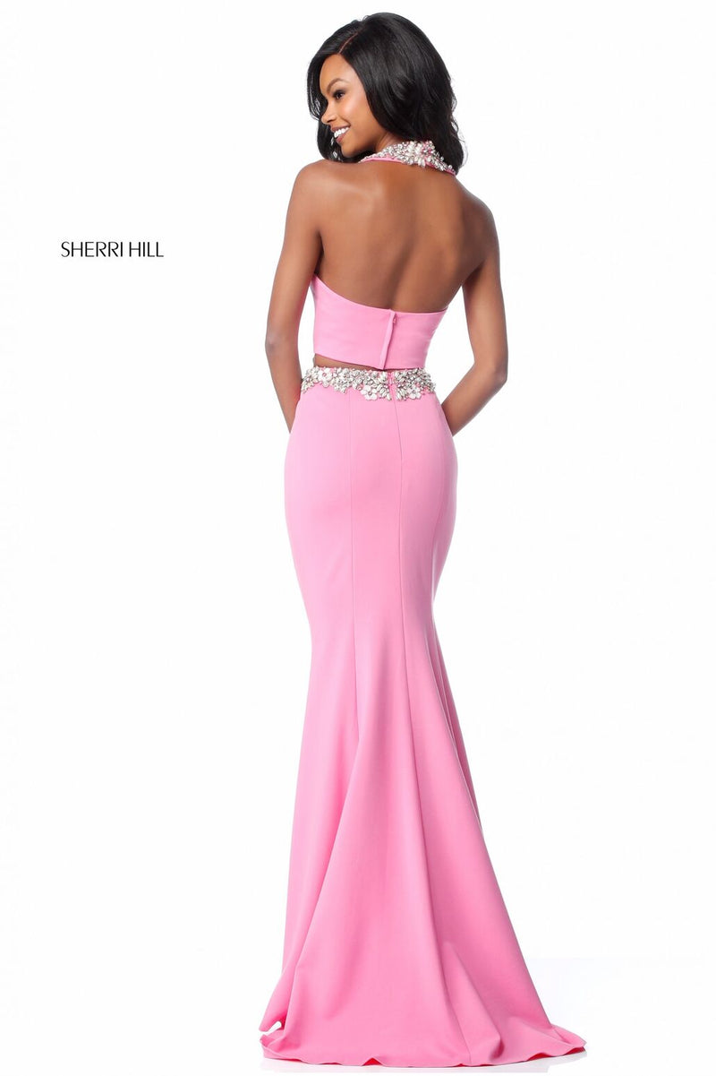 This Sherri Hill 51911 jersey two-piece gown features a high neck halter bodice and a fitted skirt with a beaded belt. 